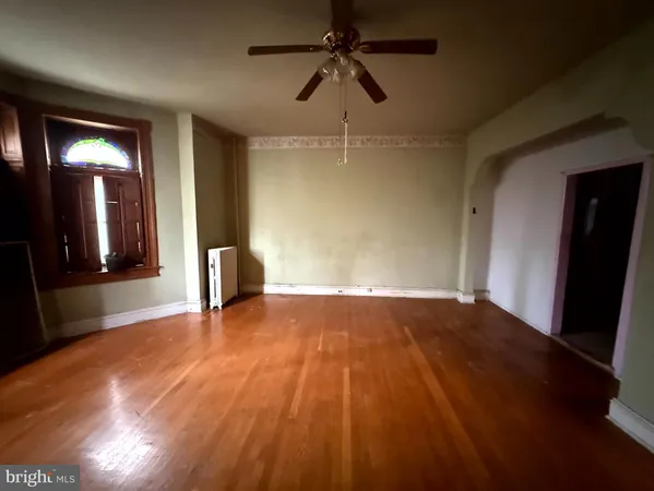 a view of an empty room and wooden floor