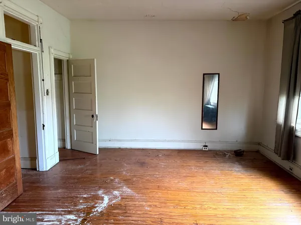 a view of room with window and hardwood floor