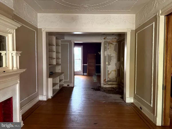 a view of a hallway with wooden floor windows and livingroom