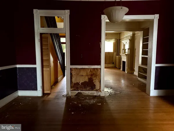 a view of a hallway with wooden floor and a fireplace