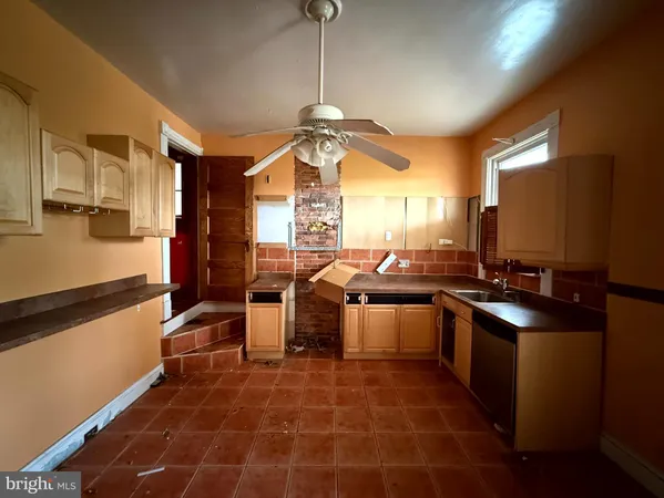 a kitchen with stainless steel appliances a sink stove and refrigerator