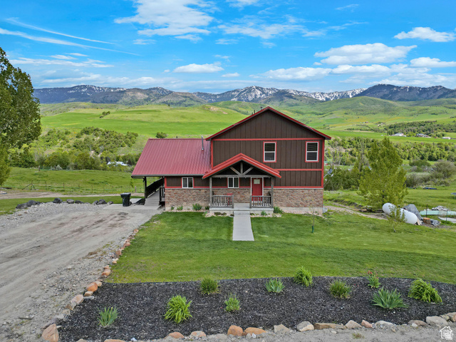 306 Spring Road Preston, ID 83263 - Photo 2 of 55 Two-story residence featuring a red metal roof and brown vertical siding
