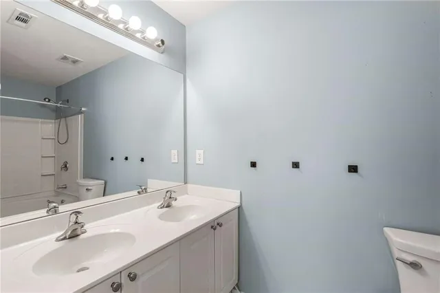 a bathroom with a sink vanity and a mirror