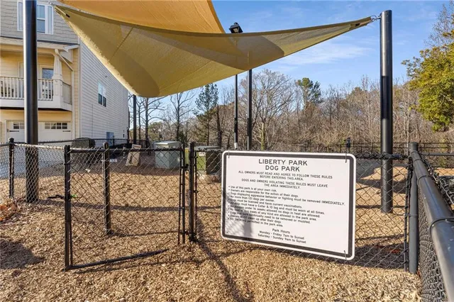 a view of a white house with a swimming pool and sitting area