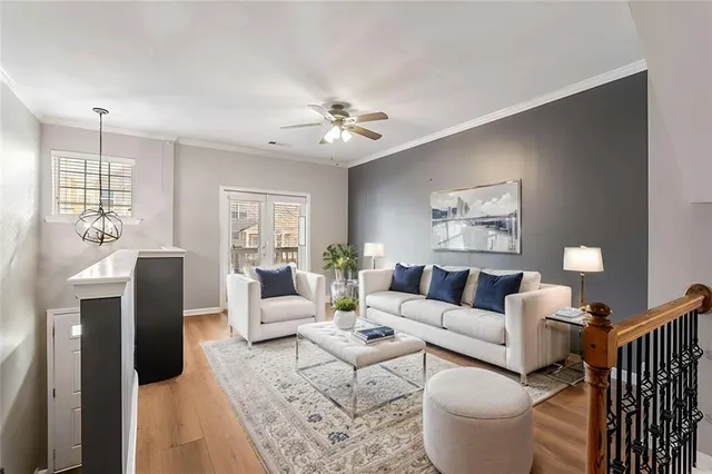 a living room with furniture a chandelier and a window