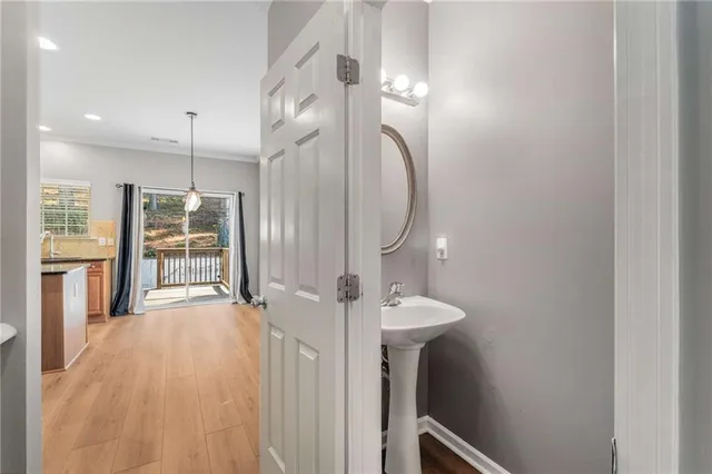 a view of a hallway with wooden floor and entryway