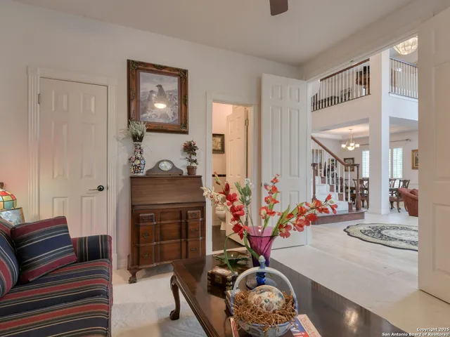 a living room with furniture and a floor to ceiling window