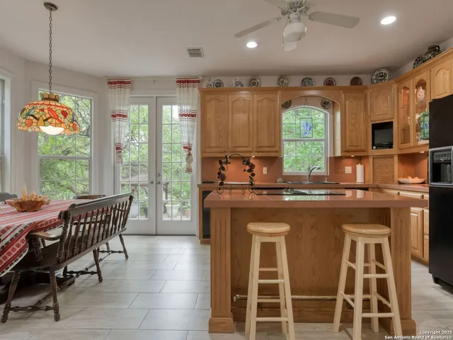 a bathroom with a tub a double vanity sink a vanity a lamp and a mirror