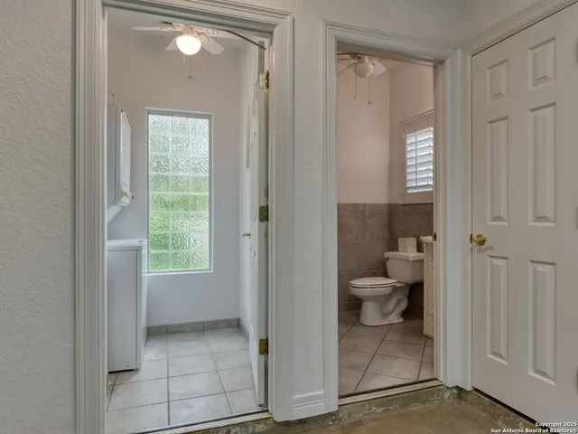 a utility room with cabinets washer and dryer