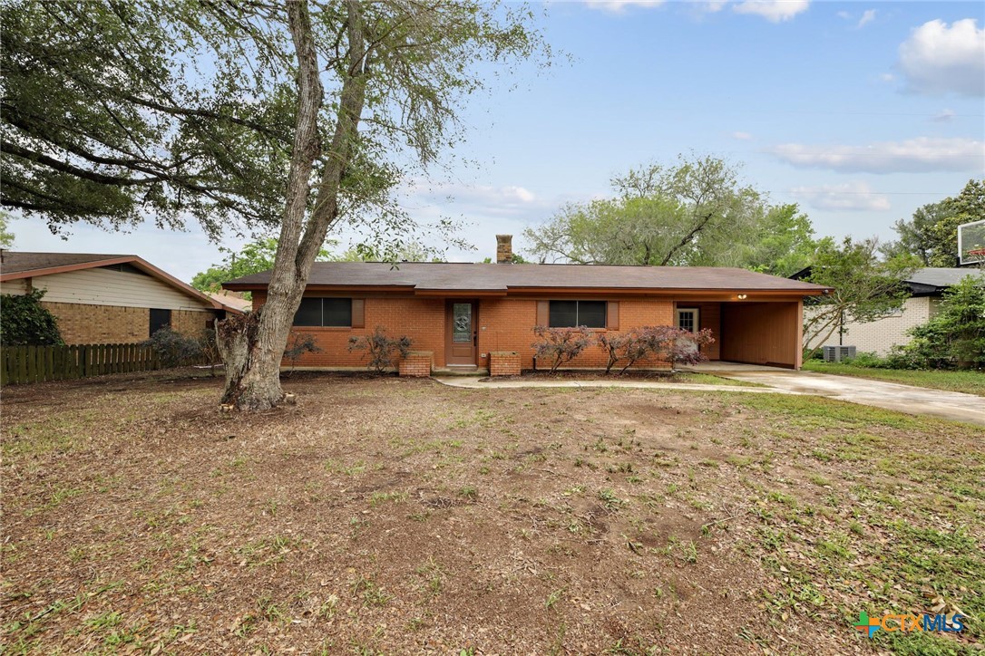 a front view of house with yard and trees