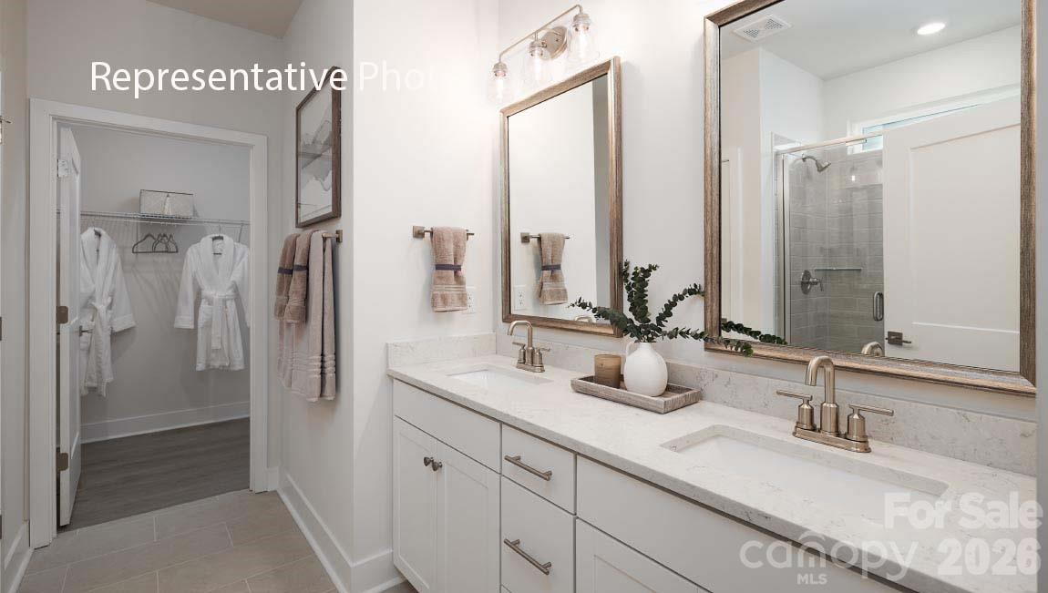 3205 Oberon Street York, SC 29745 - Photo 16 of 23 a bathroom with double vanity sinks and a mirror