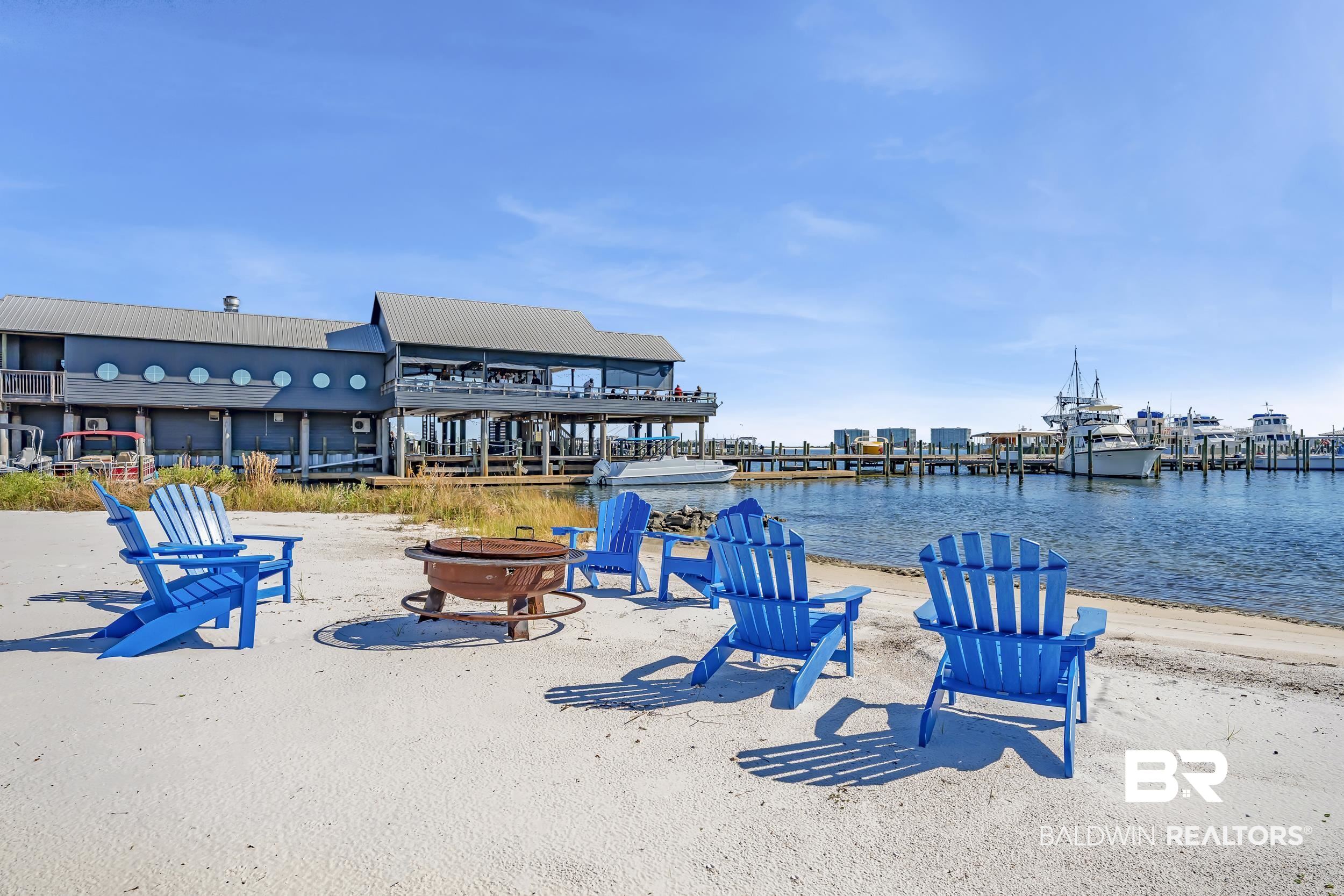27282 Canal Road, Unit 104 Orange Beach, AL 36561 - Photo 4 of 79 Surrounding community featuring an outdoor fire pit, a water view, and a patio