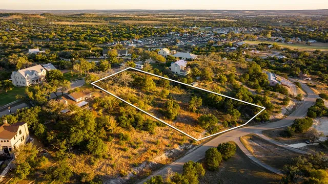an aerial view of residential houses with city view