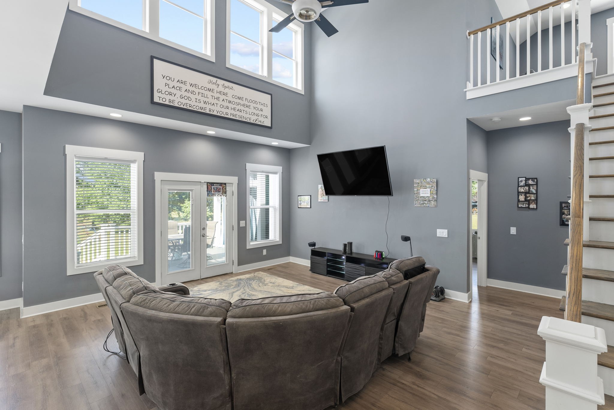4217 Sandy Springs Road Springfield, TN 37172 - Photo 13 of 50 a living room with couches a flat screen tv and a large window with wooden floor