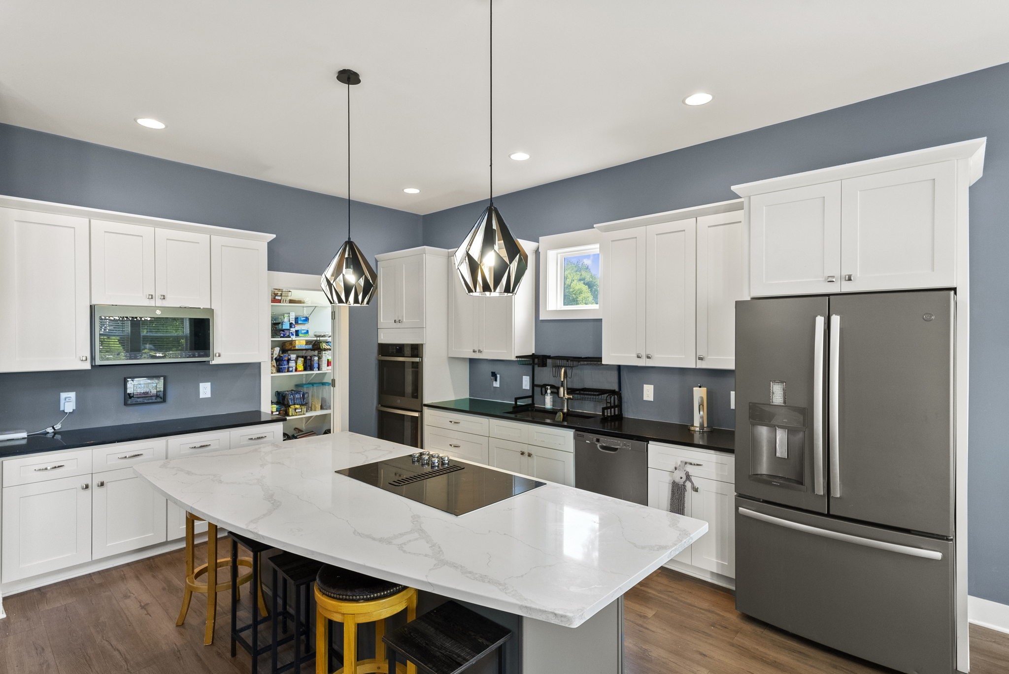 4217 Sandy Springs Road Springfield, TN 37172 - Photo 22 of 50 a kitchen with stainless steel appliances a sink a stove a refrigerator a center island and cabinets