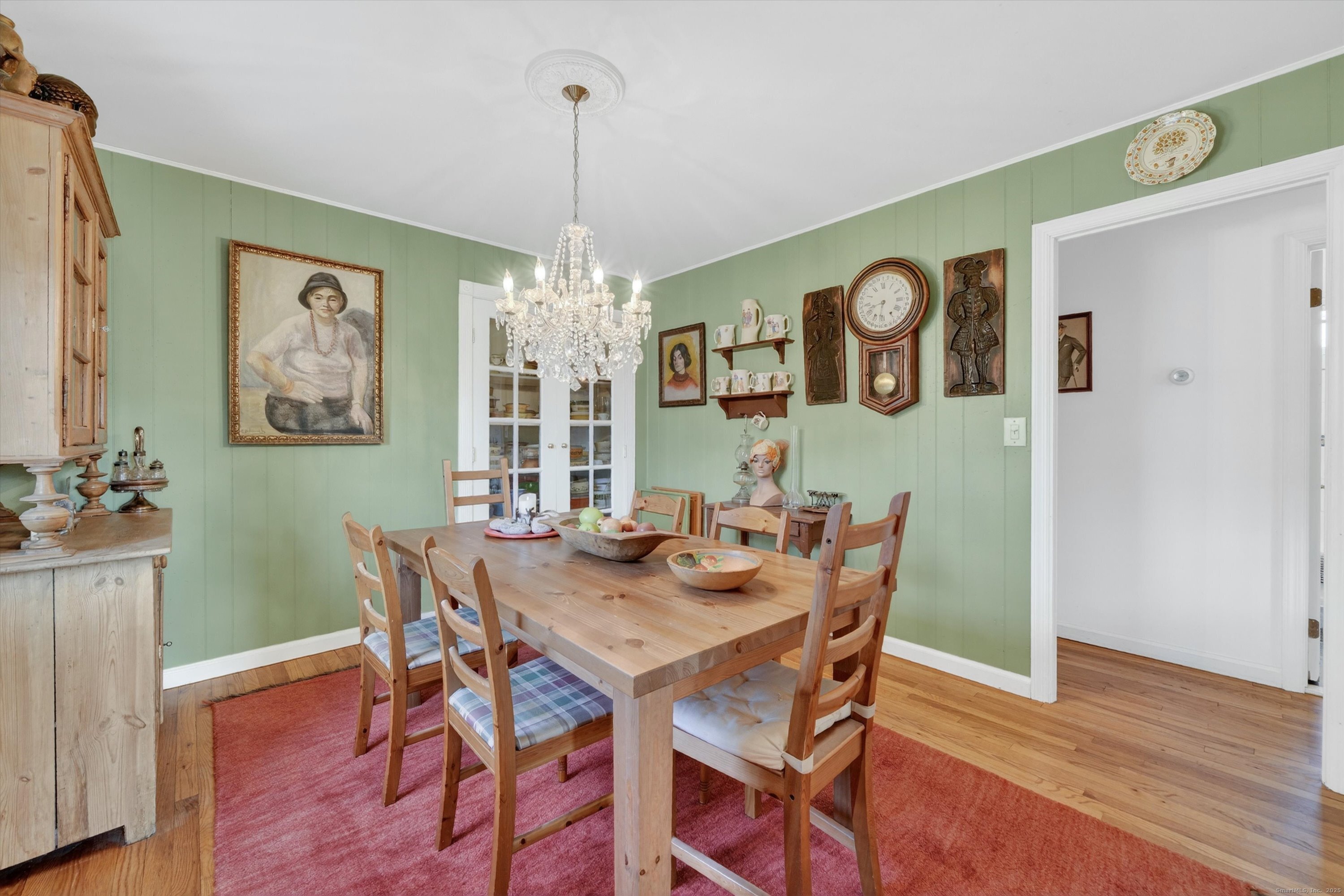 246 Romanock Road Fairfield, CT 06825 - Photo 12 of 37 a view of a dining room with furniture wooden floor and a chandelier