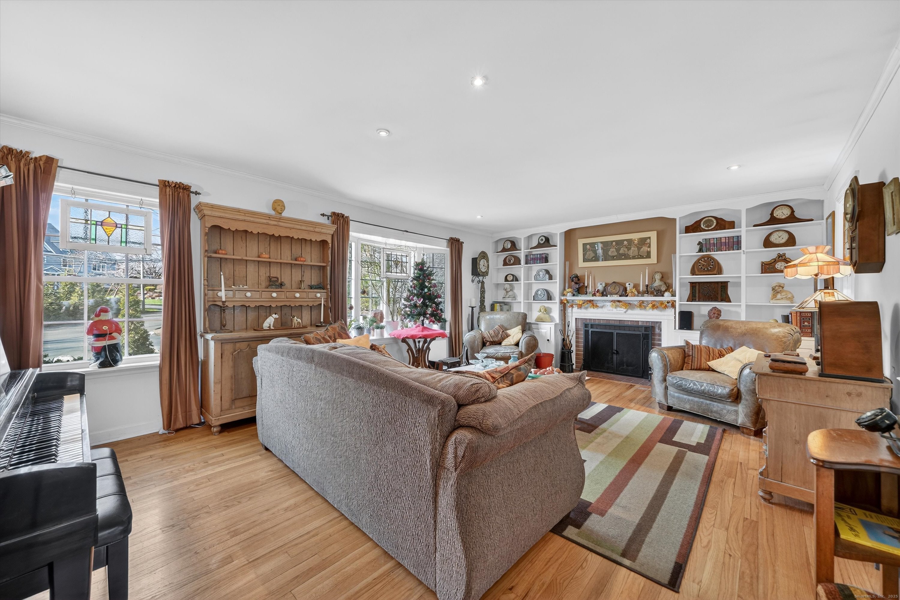 246 Romanock Road Fairfield, CT 06825 - Photo 15 of 37 a living room with furniture a fireplace and a flat screen tv