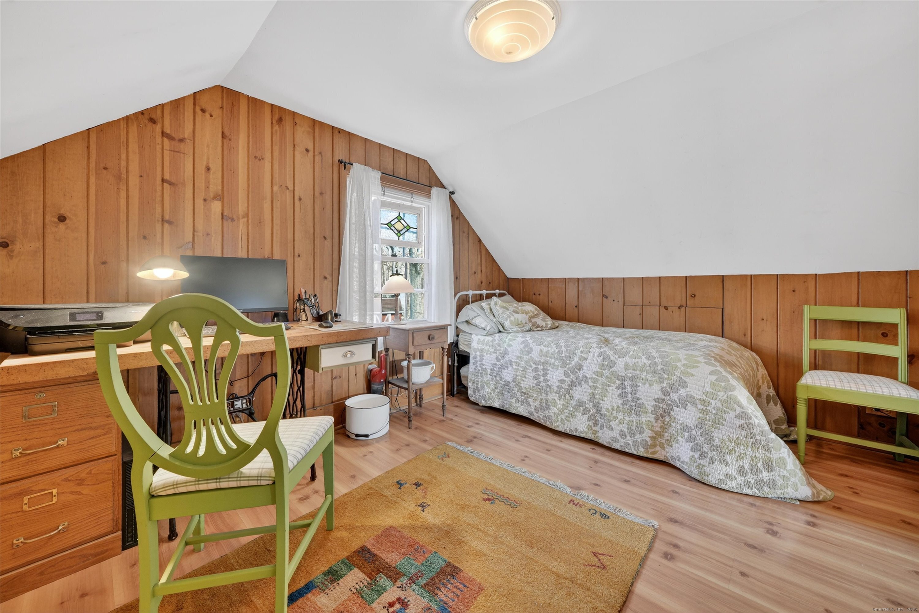 246 Romanock Road Fairfield, CT 06825 - Photo 22 of 37 a bedroom with a bed a chair and potted plant