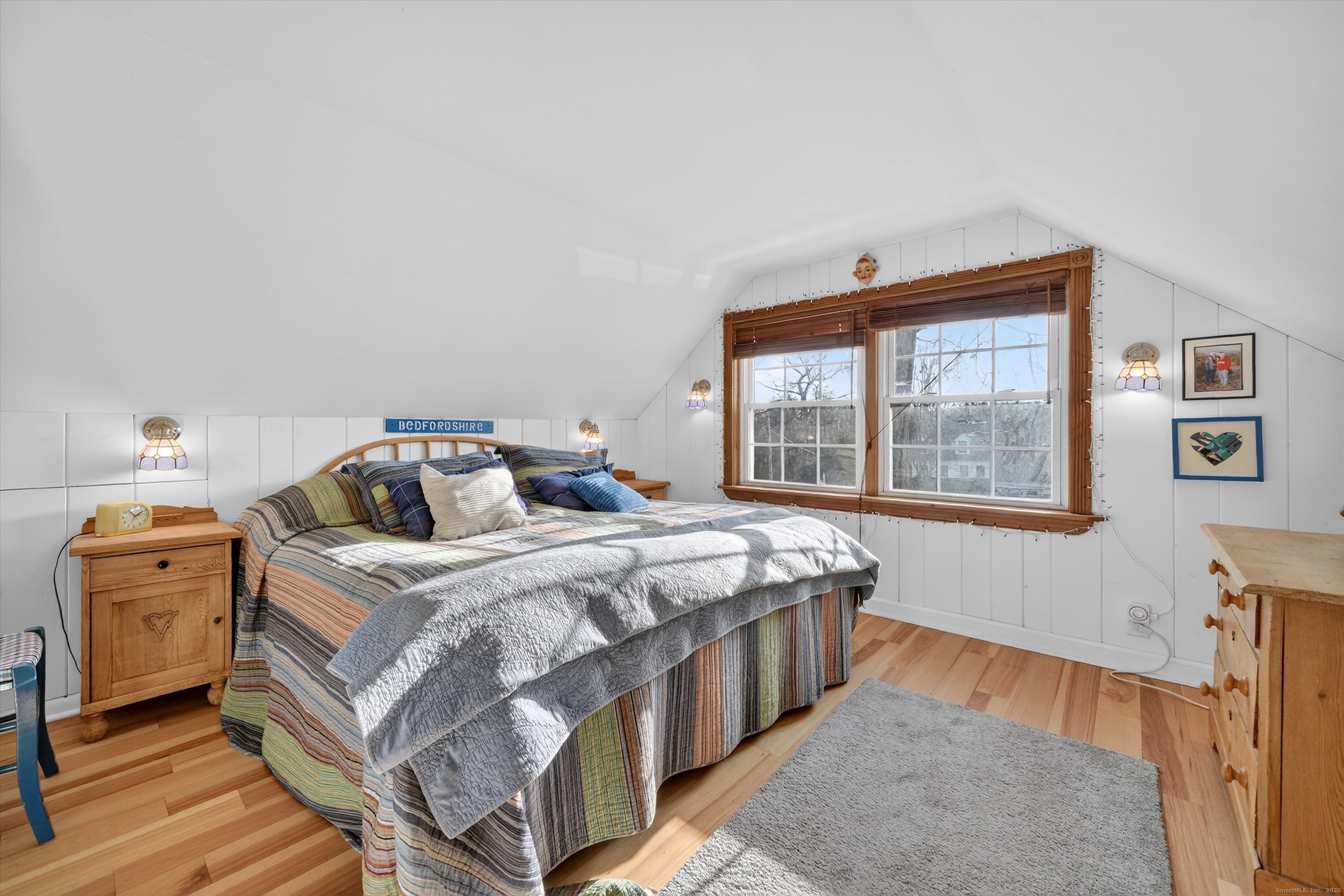 246 Romanock Road Fairfield, CT 06825 - Photo 23 of 37 a bedroom with a bed and wooden floor