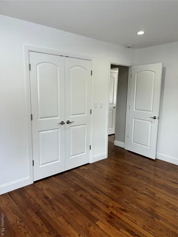 an empty room with wooden floor