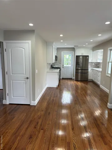 a view of a livingroom with furniture and wooden floor