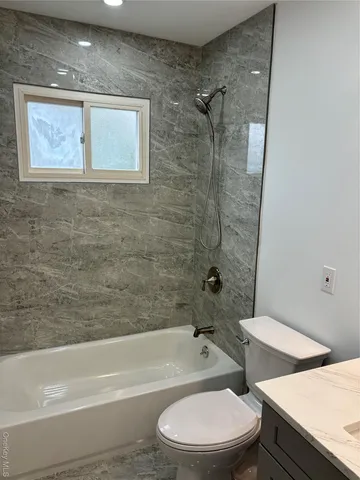 a bathroom with a toilet a sink and bathtub