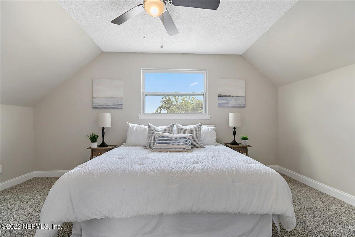 4057 Dayrl Road Jacksonville, FL 32207 - Photo 11 of 21 a bedroom with a large bed and a window