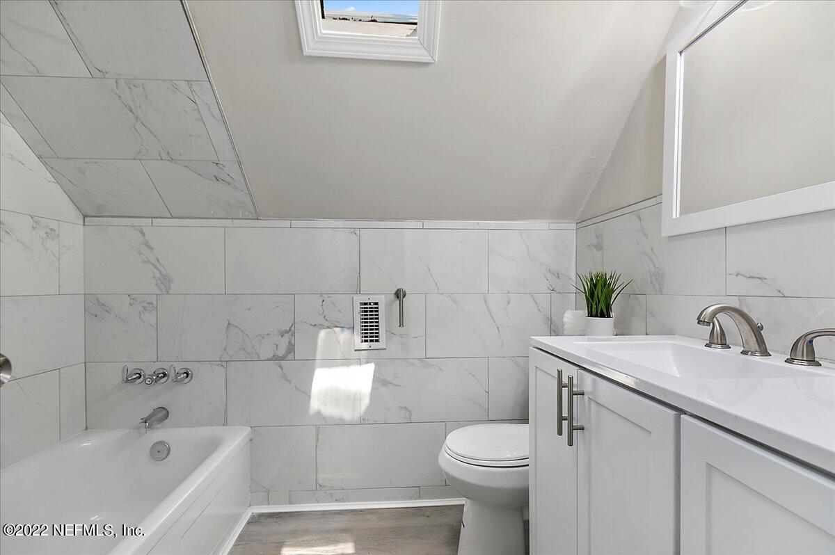 4057 Dayrl Road Jacksonville, FL 32207 - Photo 12 of 21 a bathroom with a sink a toilet and bathtub