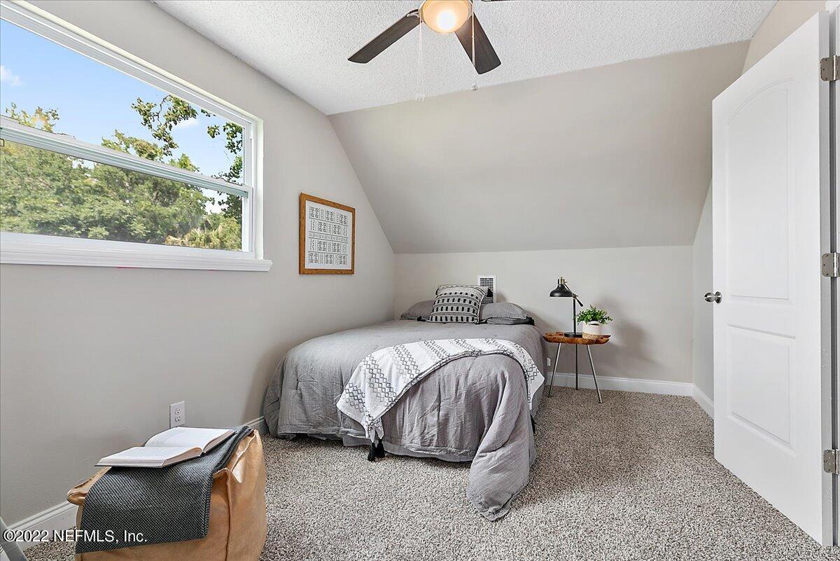 4057 Dayrl Road Jacksonville, FL 32207 - Photo 13 of 21 a bedroom with a bed and a painting on the wall