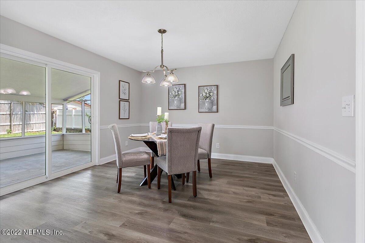 4057 Dayrl Road Jacksonville, FL 32207 - Photo 5 of 21 a view of a dining room with furniture wooden floor and chandelier
