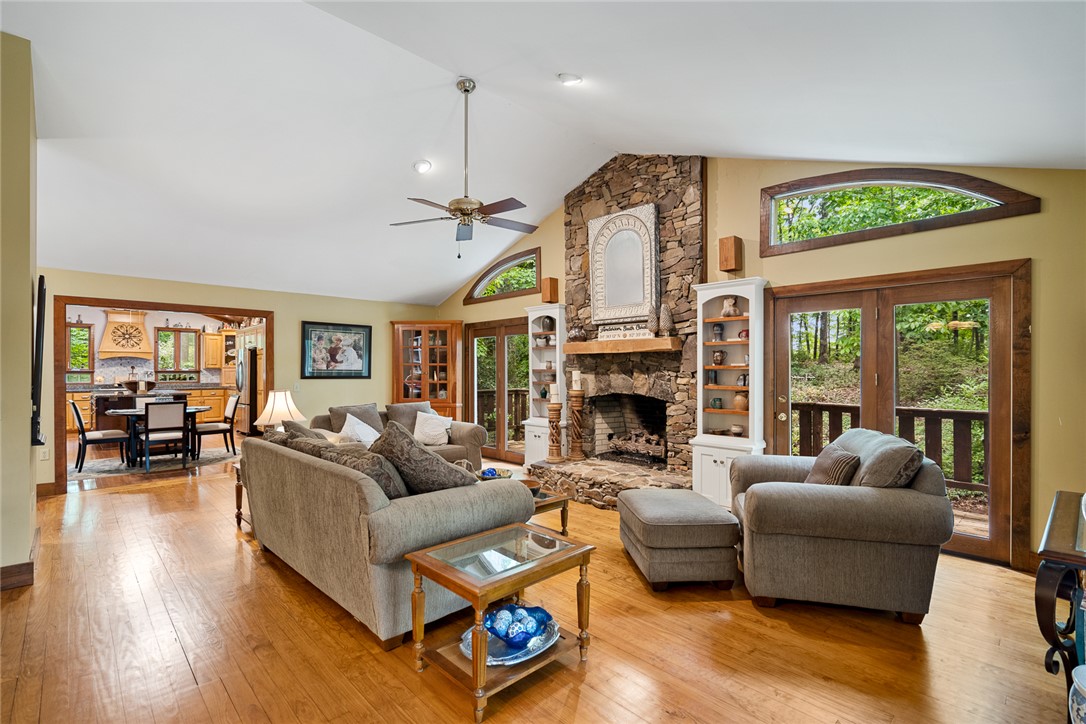 324 Hobson Road Anderson, SC 29621 - Photo 7 of 46 This inviting living area features a grand stone fireplace and warm wood floors, perfect for relaxation.