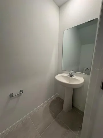 a bathroom with a sink a mirror and a toilet