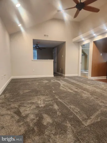 a view of an empty room with a ceiling fan