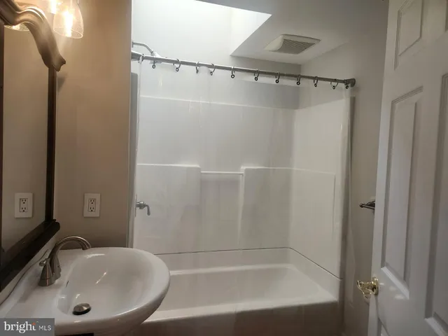 a bathroom with a sink and shower