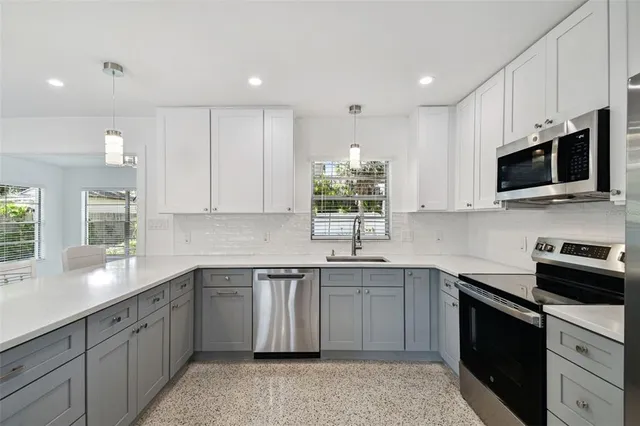 a kitchen with a sink stove and microwave