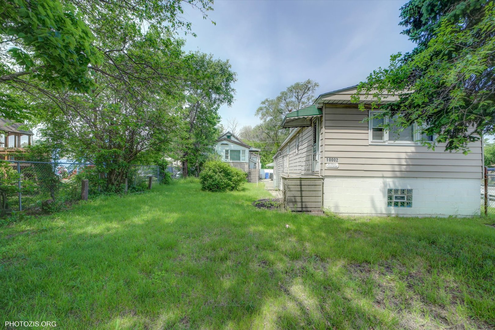 10002 South Torrence Avenue Chicago, IL 60617 - Photo 35 of 46 a view of a house with a yard