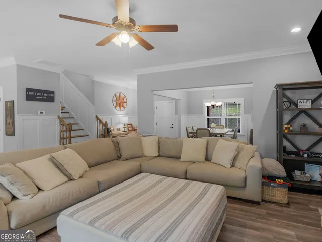 a kitchen with kitchen island a dining table chairs a sink and a chandelier