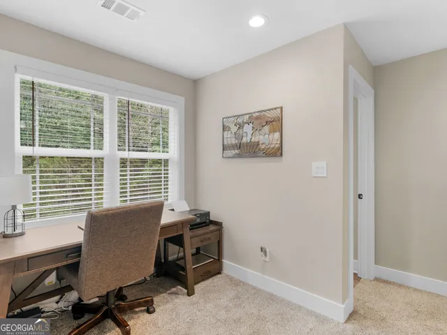a bedroom with a bed and a flat tv screen on the dresser