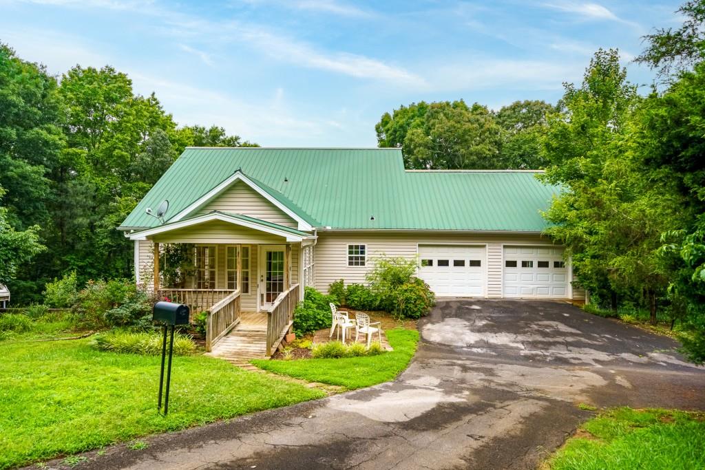 176 Big Oak Tree Road Northwest Adairsville, GA 30103 - Photo 1 of 77 a front view of a house with a yard and trees