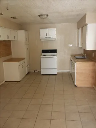 a kitchen with a stove and a cabinets