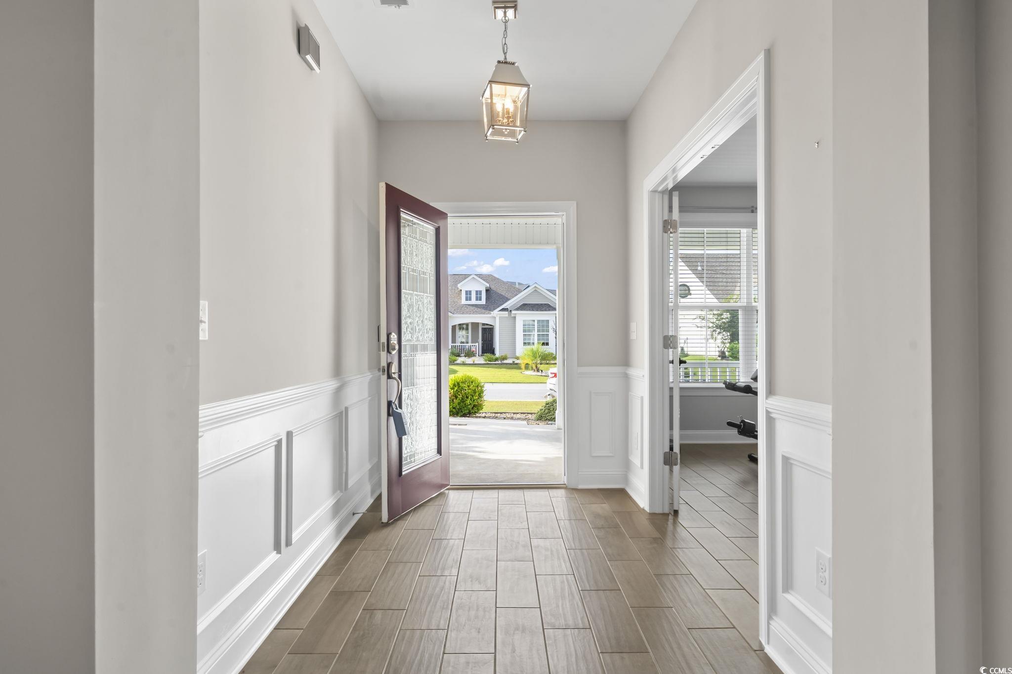 583 Hickman Street Surfside Beach, SC 29575 - Photo 14 of 40 Doorway with wainscoting, wood tiled floors, and a decorative wall