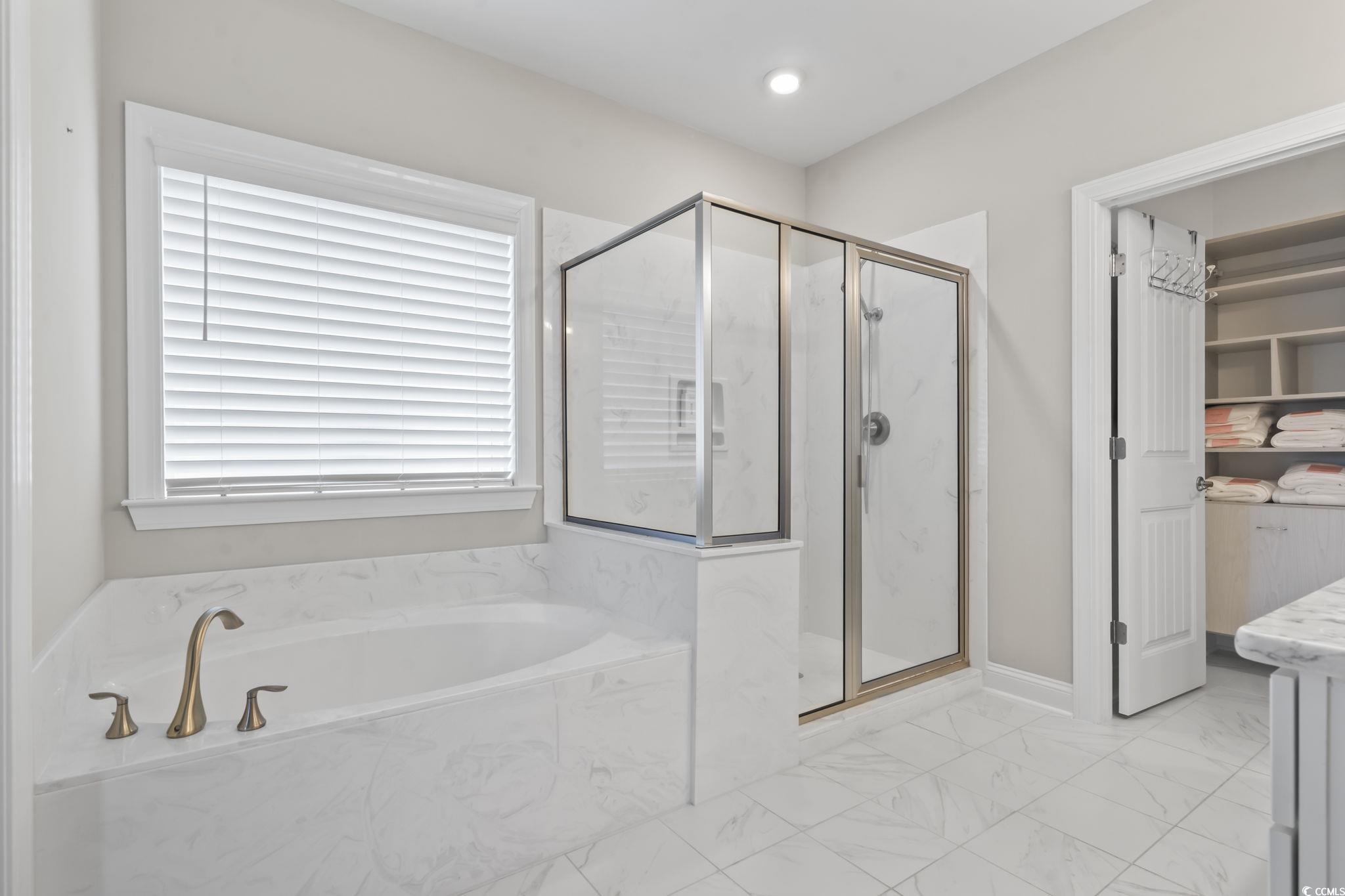 583 Hickman Street Surfside Beach, SC 29575 - Photo 26 of 40 Bathroom with a marble finish shower, a garden tub, light marble finish floors, and vanity
