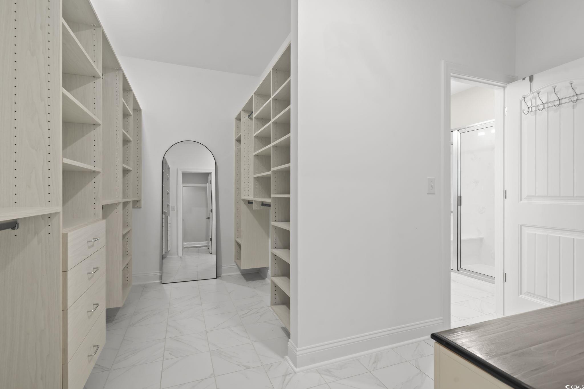 583 Hickman Street Surfside Beach, SC 29575 - Photo 27 of 40 Walk in closet with light marble finish flooring and arched walkways