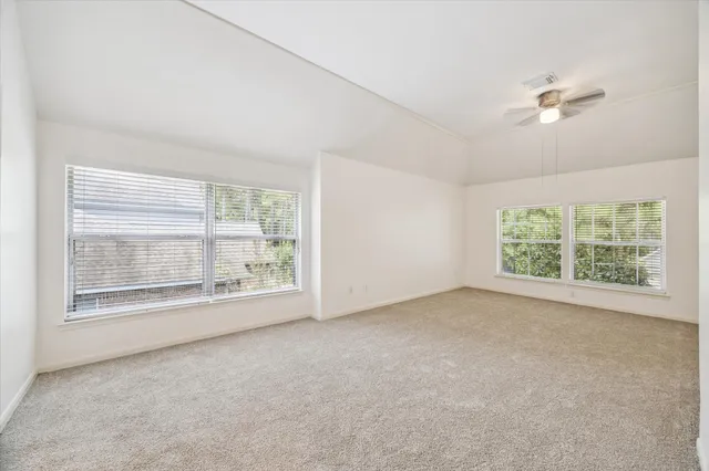 a view of room with window and ceiling fan