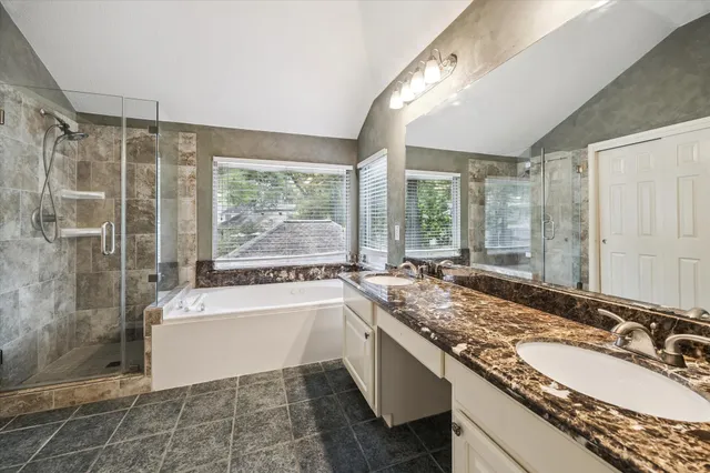 a bathroom with a granite countertop sink and a large mirror