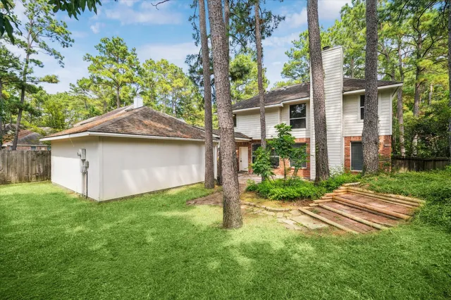 a white house that has a tree in front of it