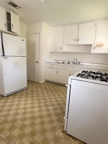 a kitchen with a cabinets and a stove top oven