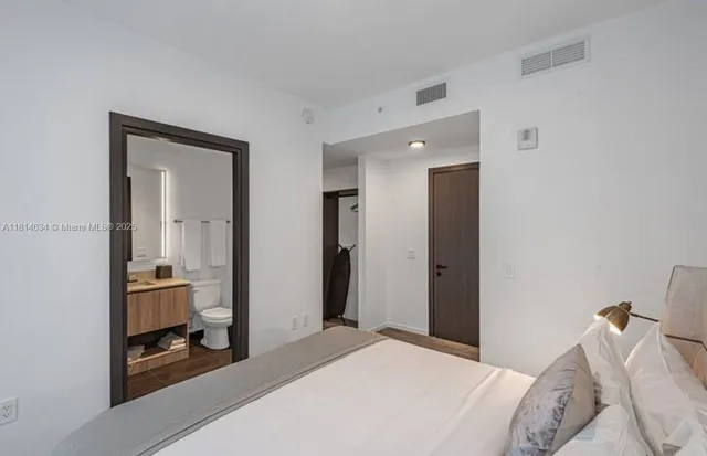 a bedroom with a bed and a mirror