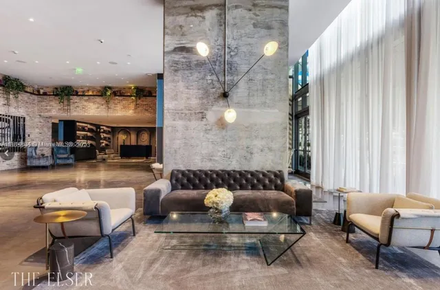 a living room with furniture and a chandelier