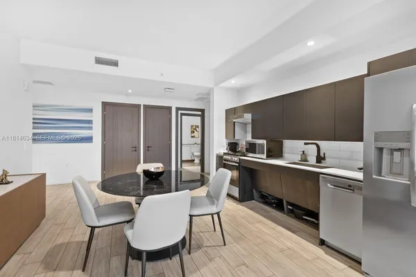 a bathroom with a tub sink and mirror